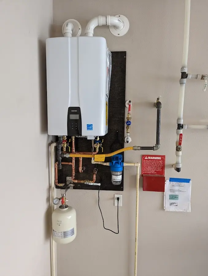 Professional plumber installing copper piping in a Bryan home